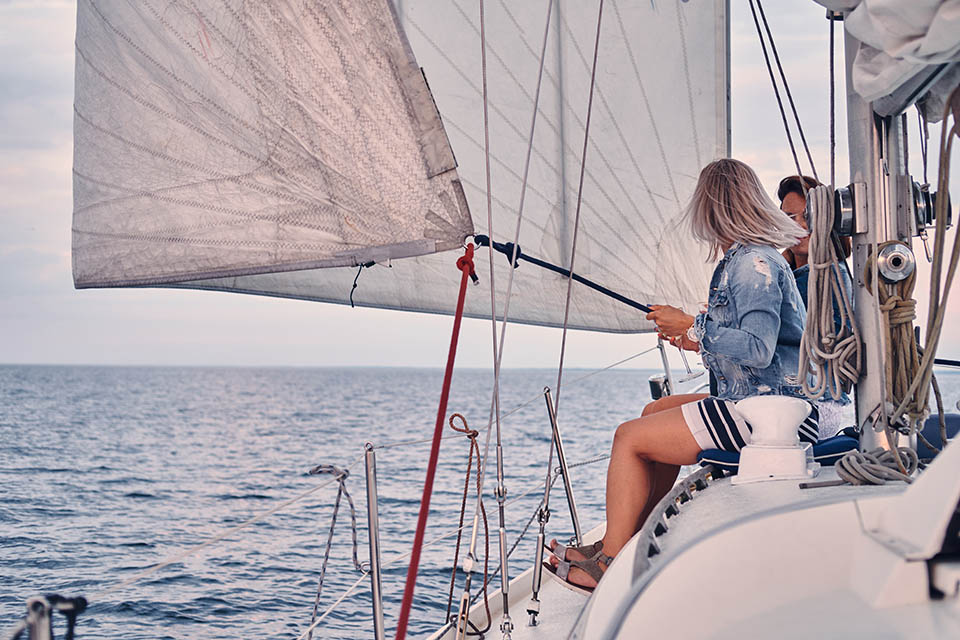 Female friends relaxing on the yacht during sunset on the high seas.